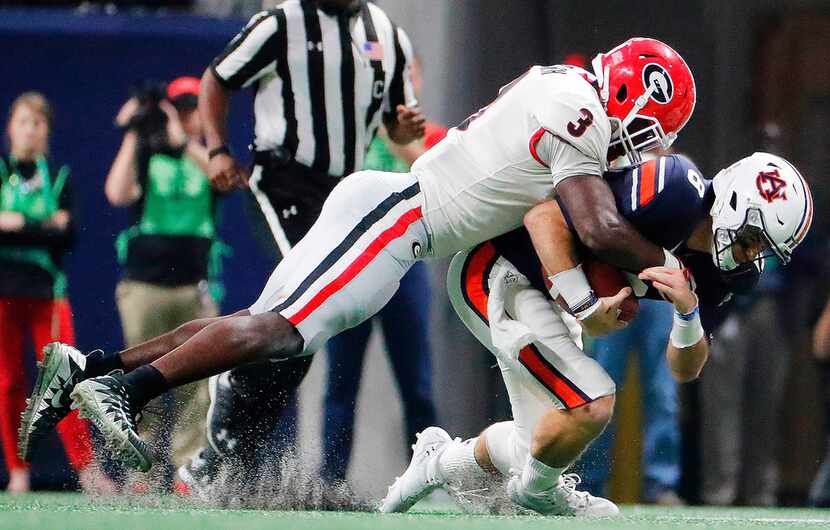 FILE - In this Dec. 2, 2017, file photo, Georgia linebacker Roquan Smith (3) tackles Auburn...