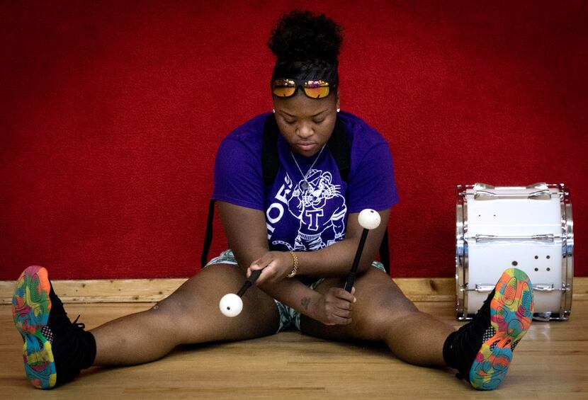 Todja Washington, 18, waits for the Dallas Mass Band practice to begin at the Braswell Child...