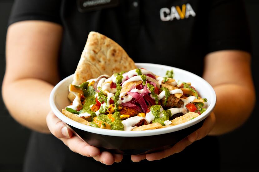 GM Rachael Lawler holds a custom bowl with pita bread at Cava in Dallas.