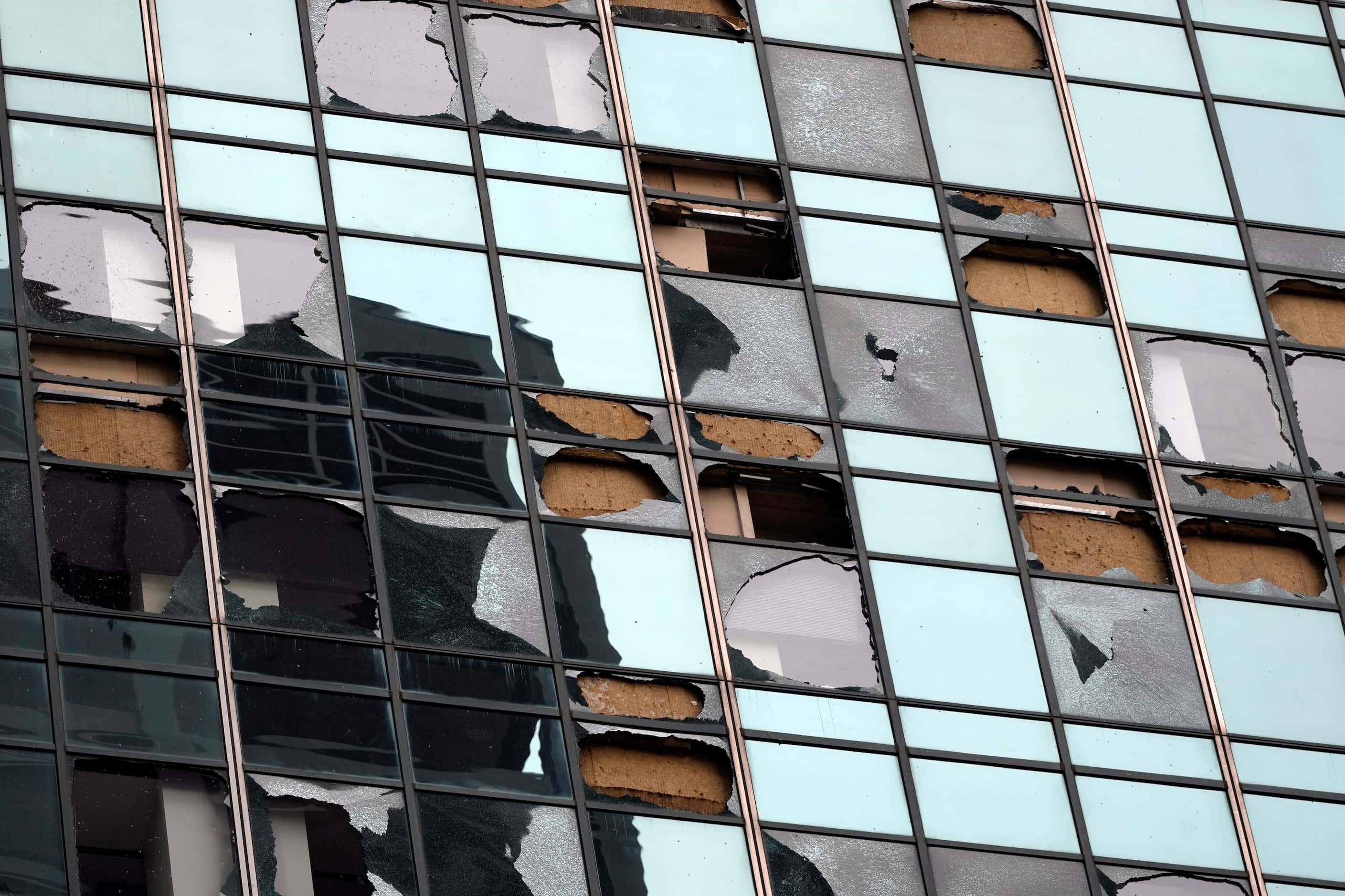 Blown out windows on a high-rise downtown building are shown in the aftermath of a severe...