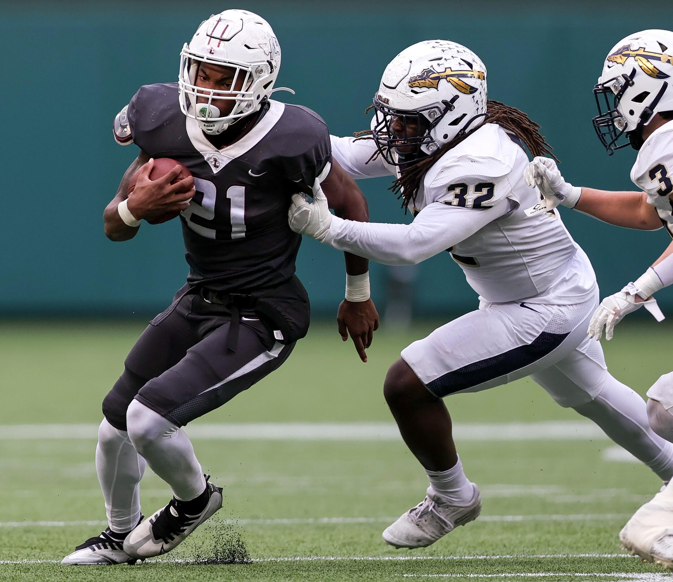 Lewisville running back Viron Ellison (21) tries to get around the corner against Keller...