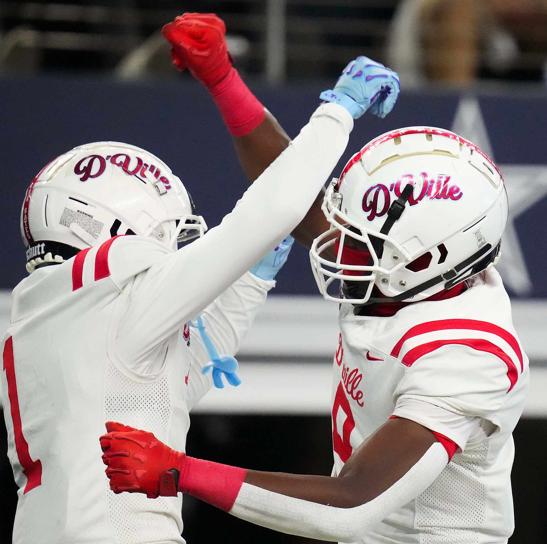 Duncanville’s Dakorien Moore (1) celebrates with Zach Turner (9) after catching a 39-yard...