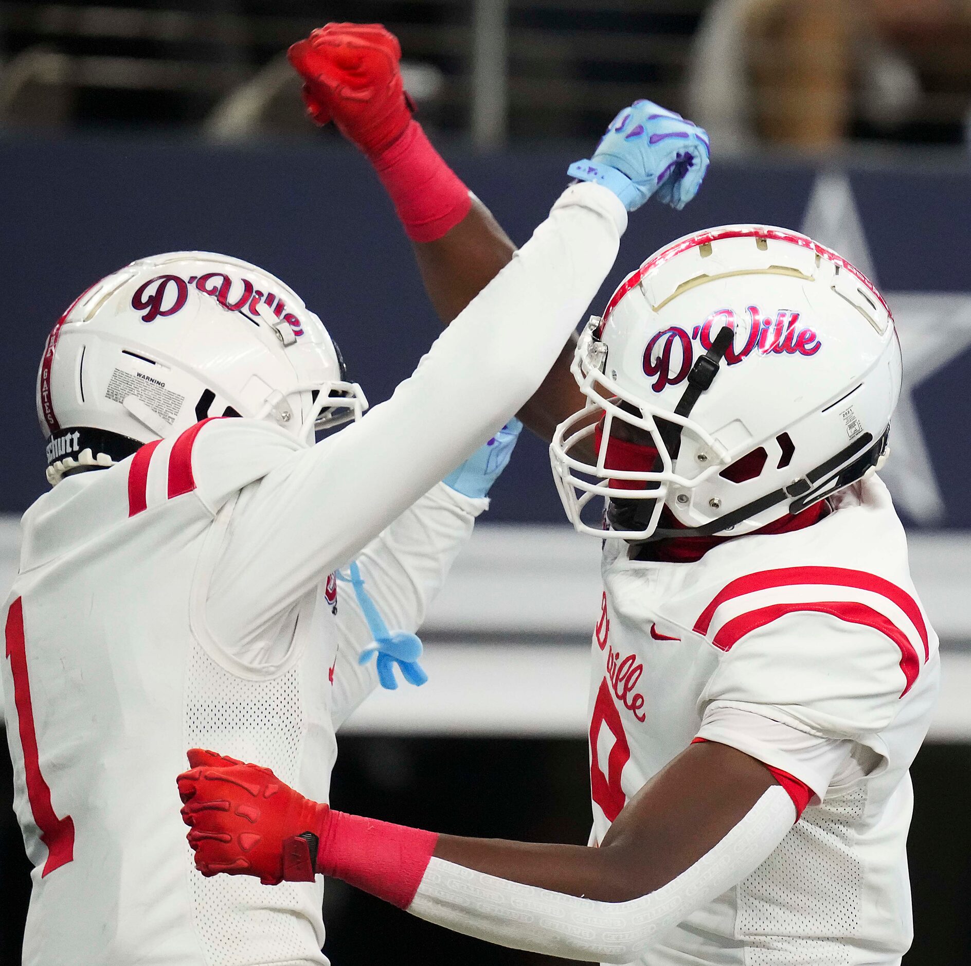 Duncanville’s Dakorien Moore (1) celebrates with Zach Turner (9) after catching a 39-yard...