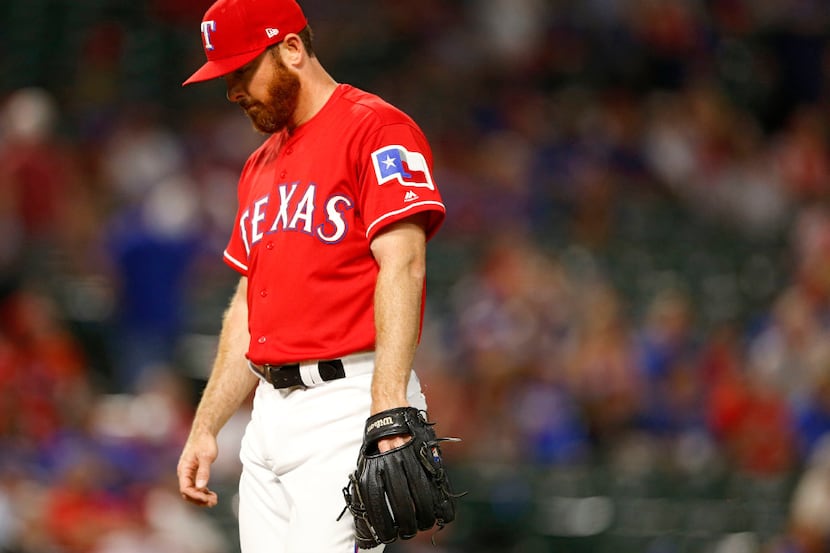 Texas Rangers relief pitcher Sam Dyson (47) exits the field after Texas Rangers manager Jeff...
