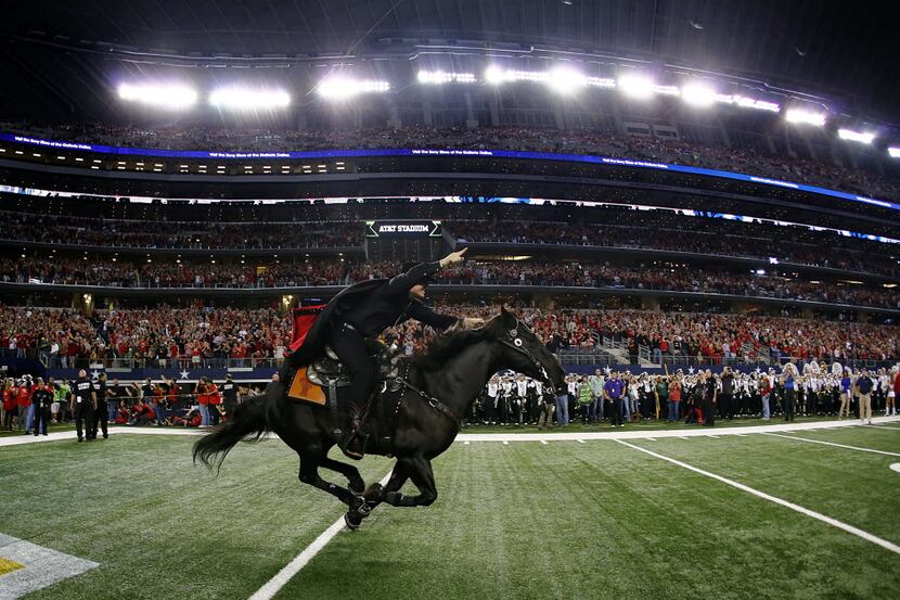 The Texas Tech Masked Rider leads the team onto the field to face the Baylor Bears at AT&T...