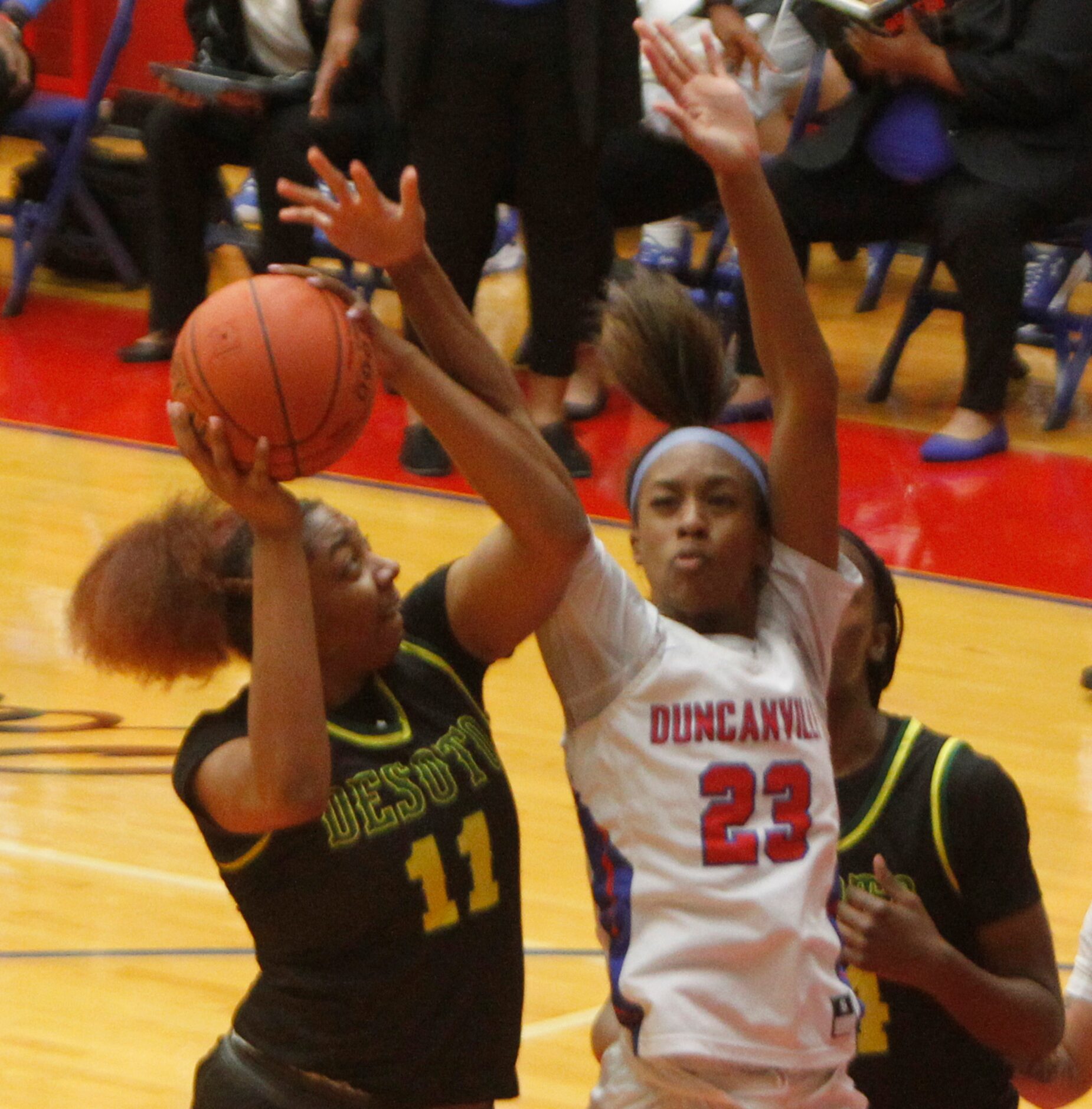 DeSoto's Tionna Herron (11) shoots as Duncanville's Kiersten Johnson (23) during first half...