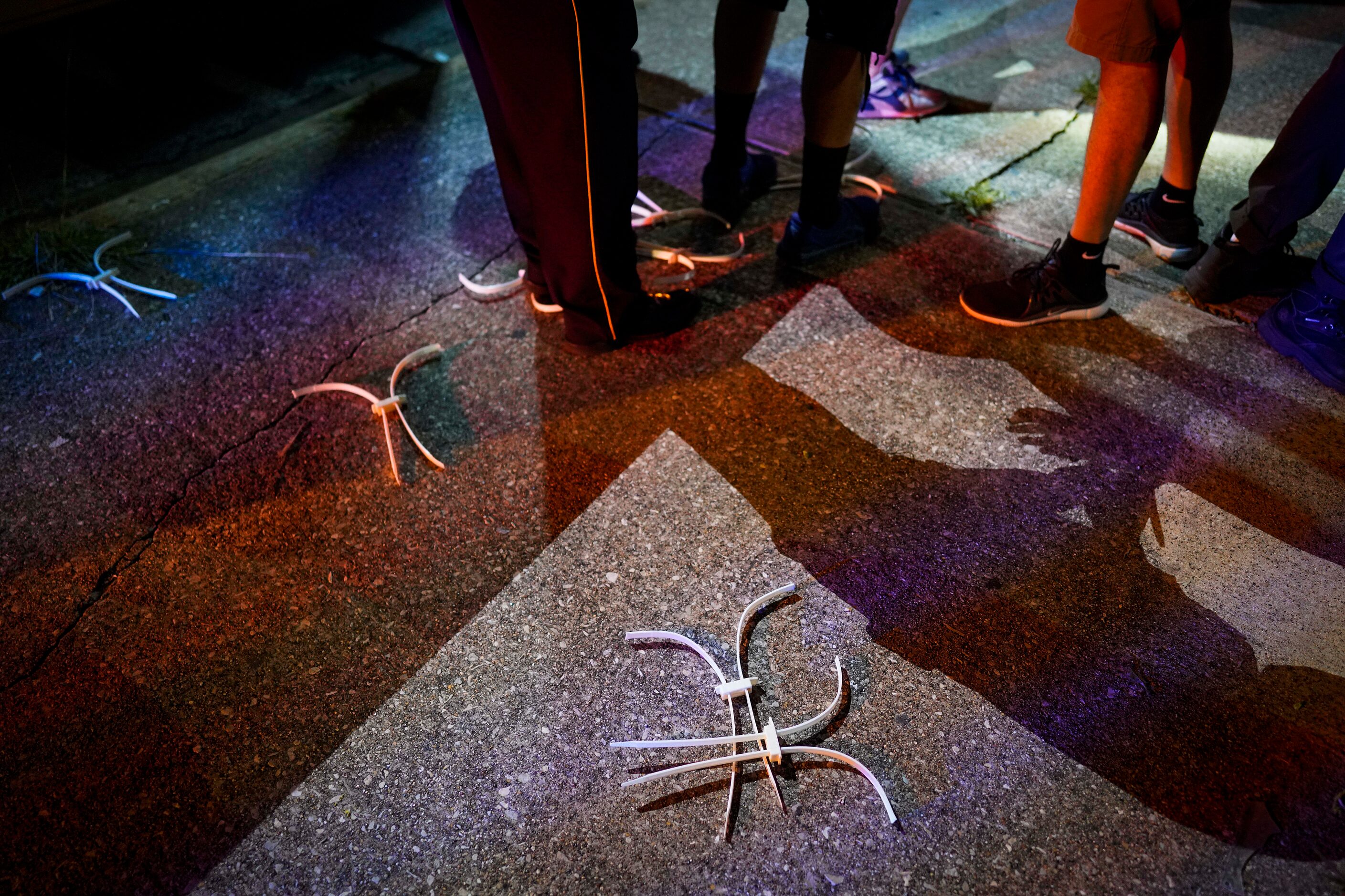 Disposable cuffs litter the sidewalk as protesters are released outside the Frank Crowley...