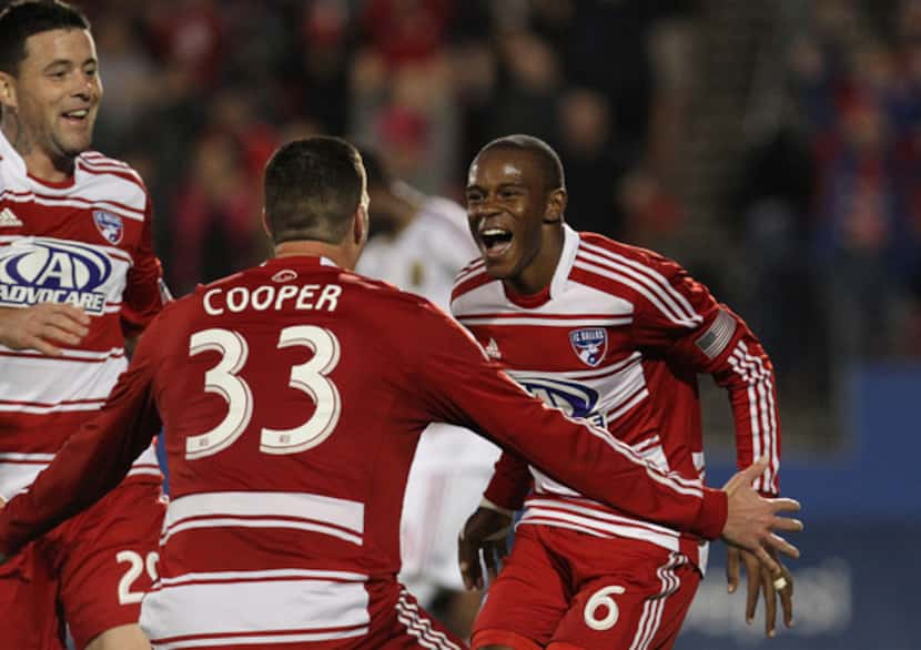 Kenny Cooper #33 celebrates with is teammates at FC Dallas