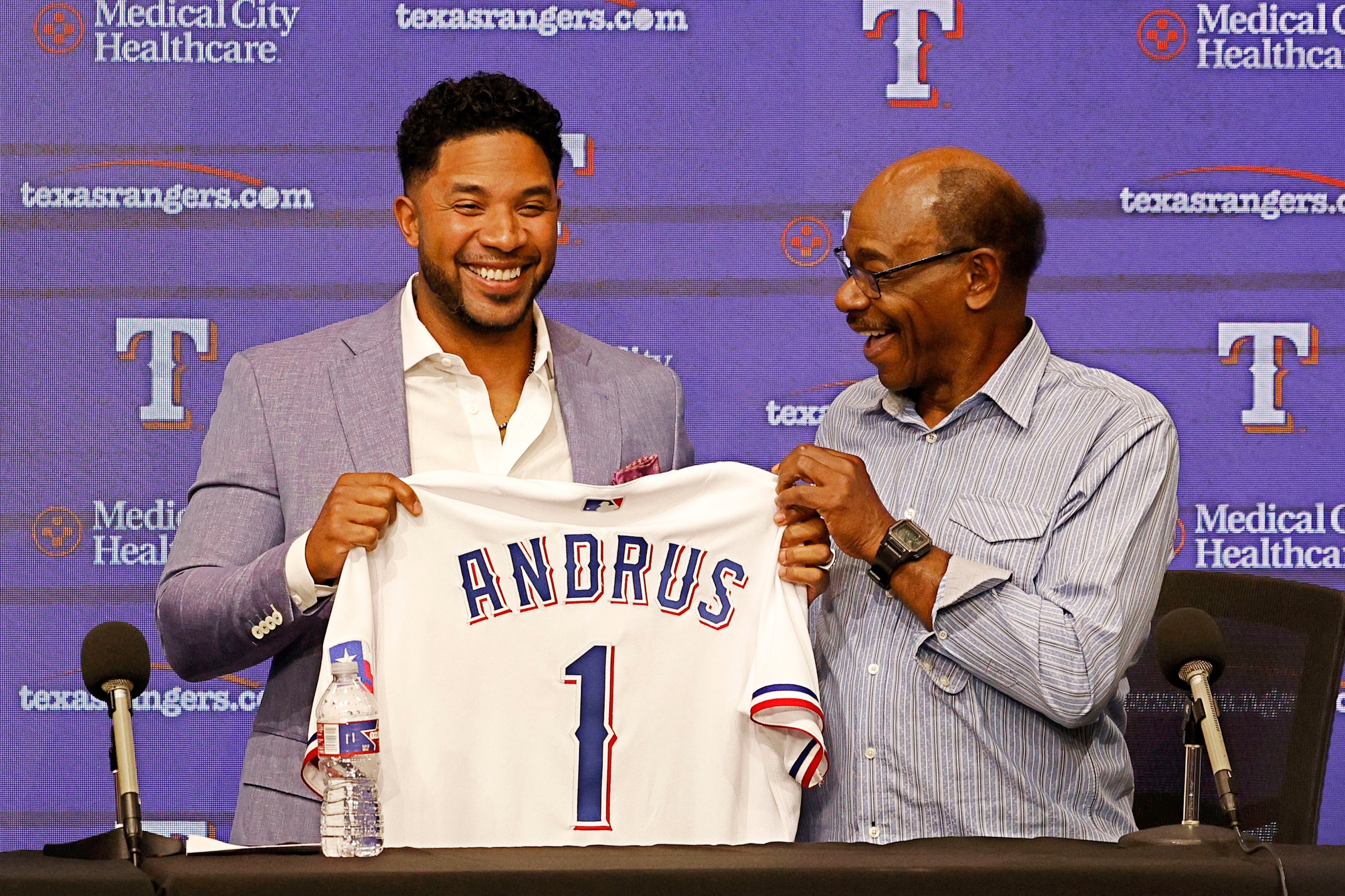 Texas Rangers' Elvis Andrus, left, holds his jersey with Los Angeles Angels Manager Ron...