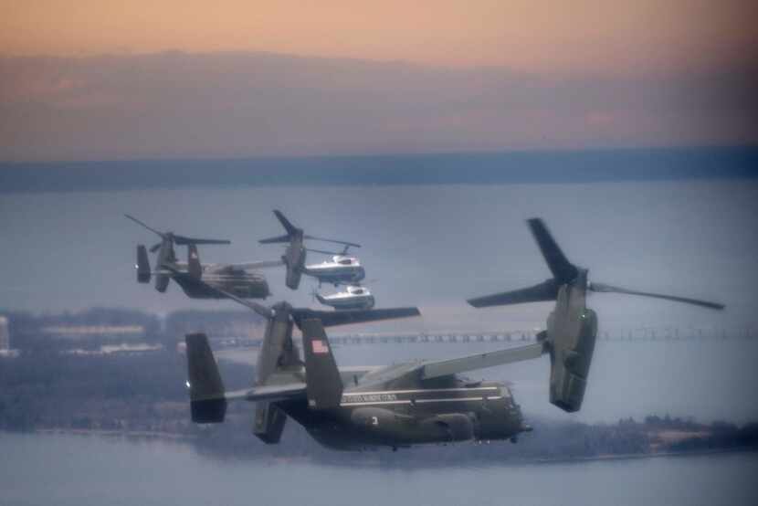 Marine One, accompanied by a convoy consisting of a decoy helicopter and V-22 Ospreys, flew...