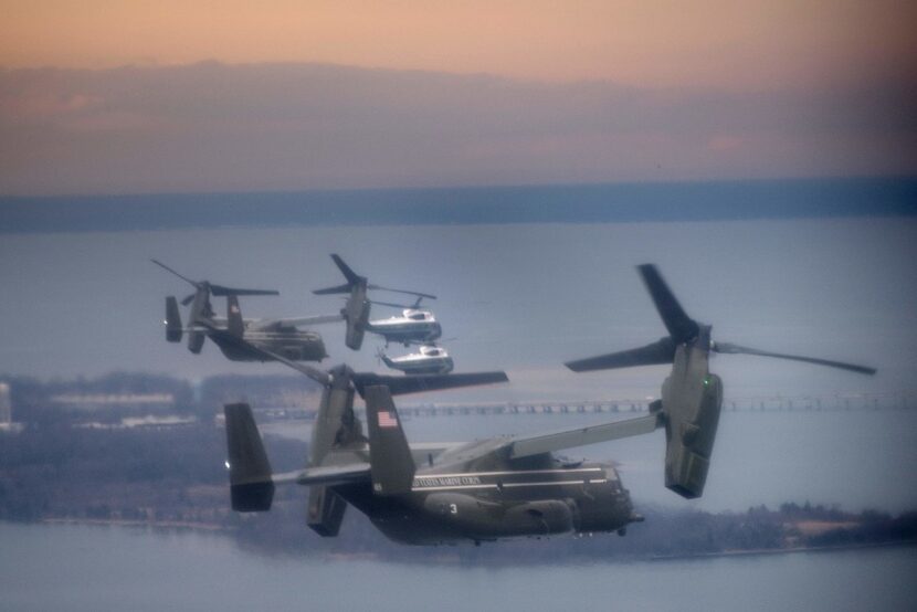 Marine One, accompanied by a convoy consisting of a decoy helicopter and V-22 Ospreys, flew...