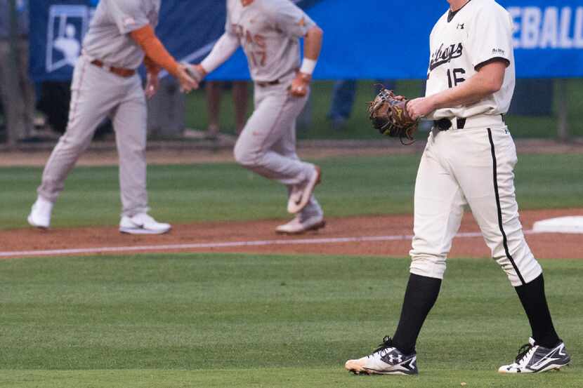 Long Beach State pitcher Darren McCaughan (16) waits for Texas' Bret Boswell (17) to round...