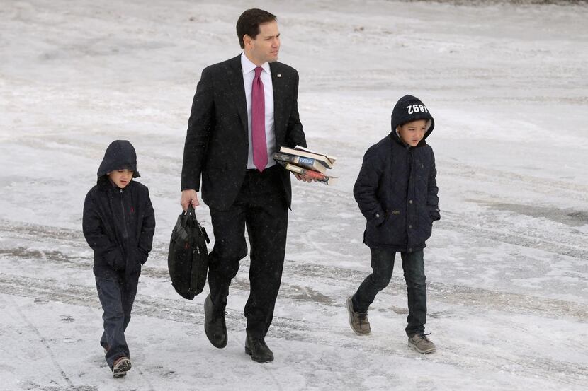 
Republican presidential candidate Marco Rubio and his sons Anthony and Dominick walk across...