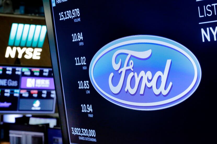 The logo for Ford appears above a trading post on the floor of the New York Stock Exchange...