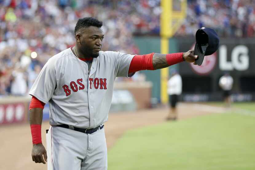 Boston Red Sox player David Ortiz waves to the fans before Ortiz is presented with gifts at...