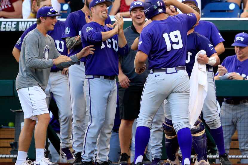 TCU's Luken Baker (19) celebrates with his teammates after hitting a home run against...