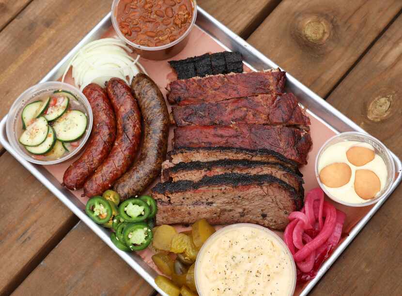 A platter at Smokey Joe's BBQ includes (from top) Beverly Beans with brisket trimmings, a...