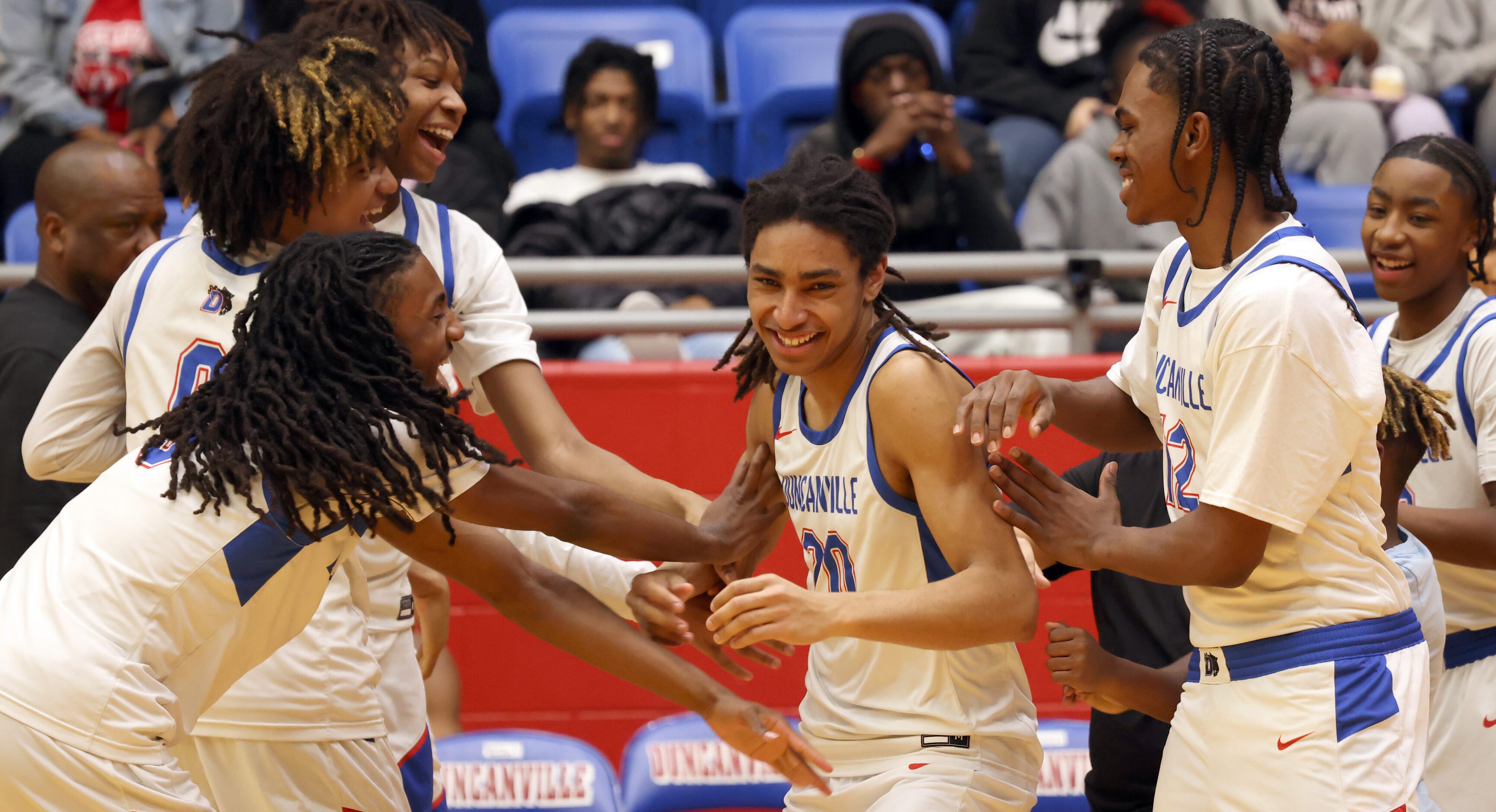 Duncanville's Anijae Mcmillion (20) was all smiles as his teammates  greeted him during...