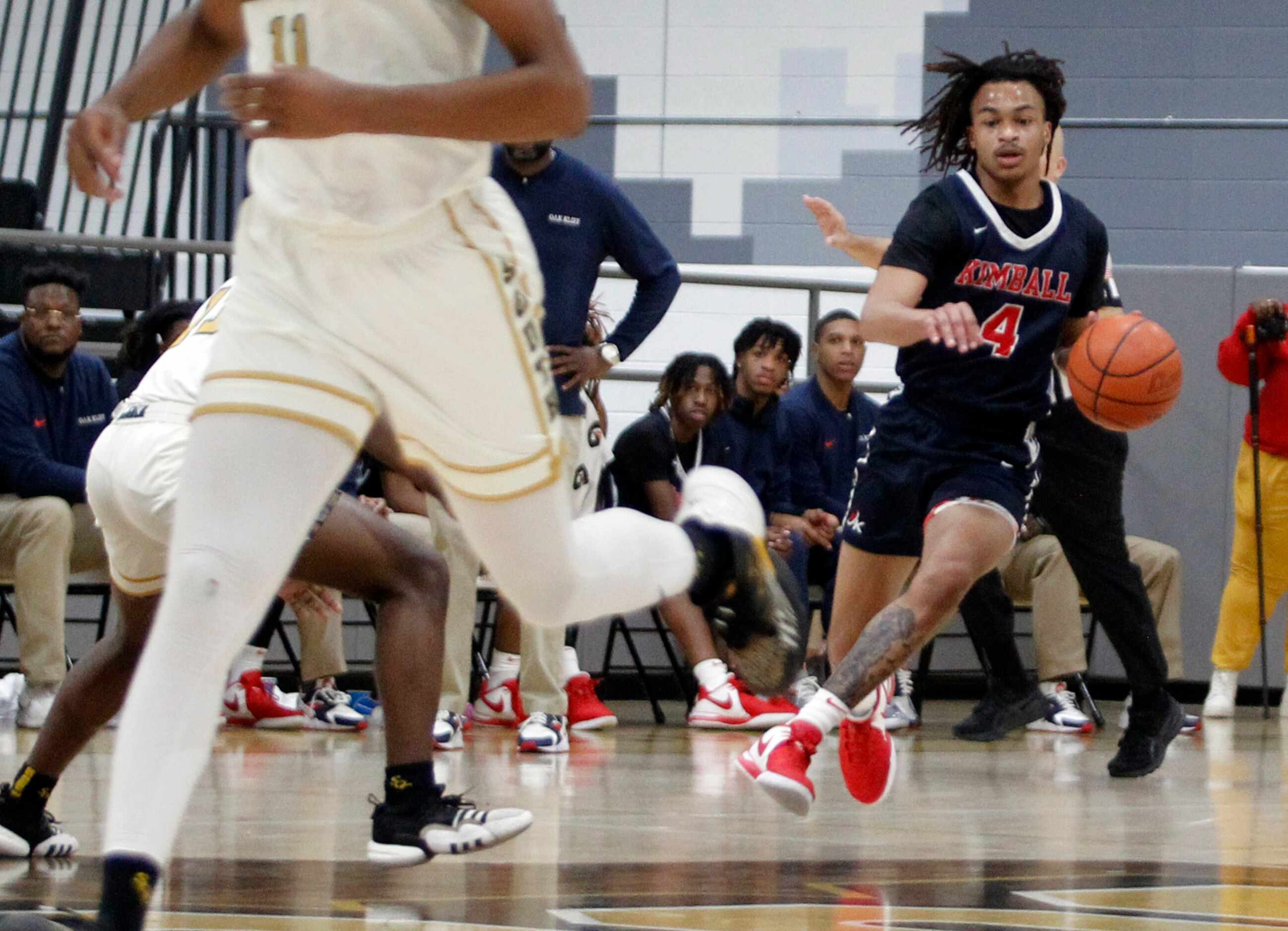 Kimball's Jonah Brandon (4), right, brings the ball up court during first half action...