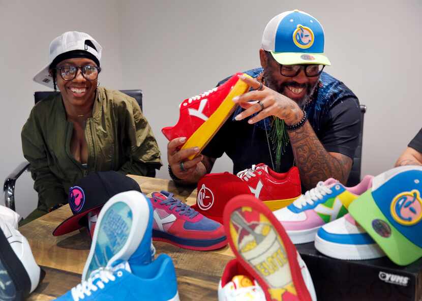 Tex Moton (right), founder and designer of the YUMS streetwear brand, and Juelz look over a...