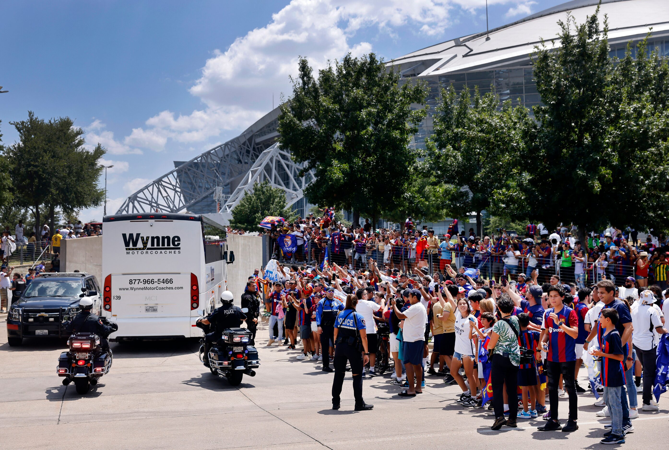 Barcelona soccer fans cheer as their team buses arrive for a Soccer Champions Tour futbol...