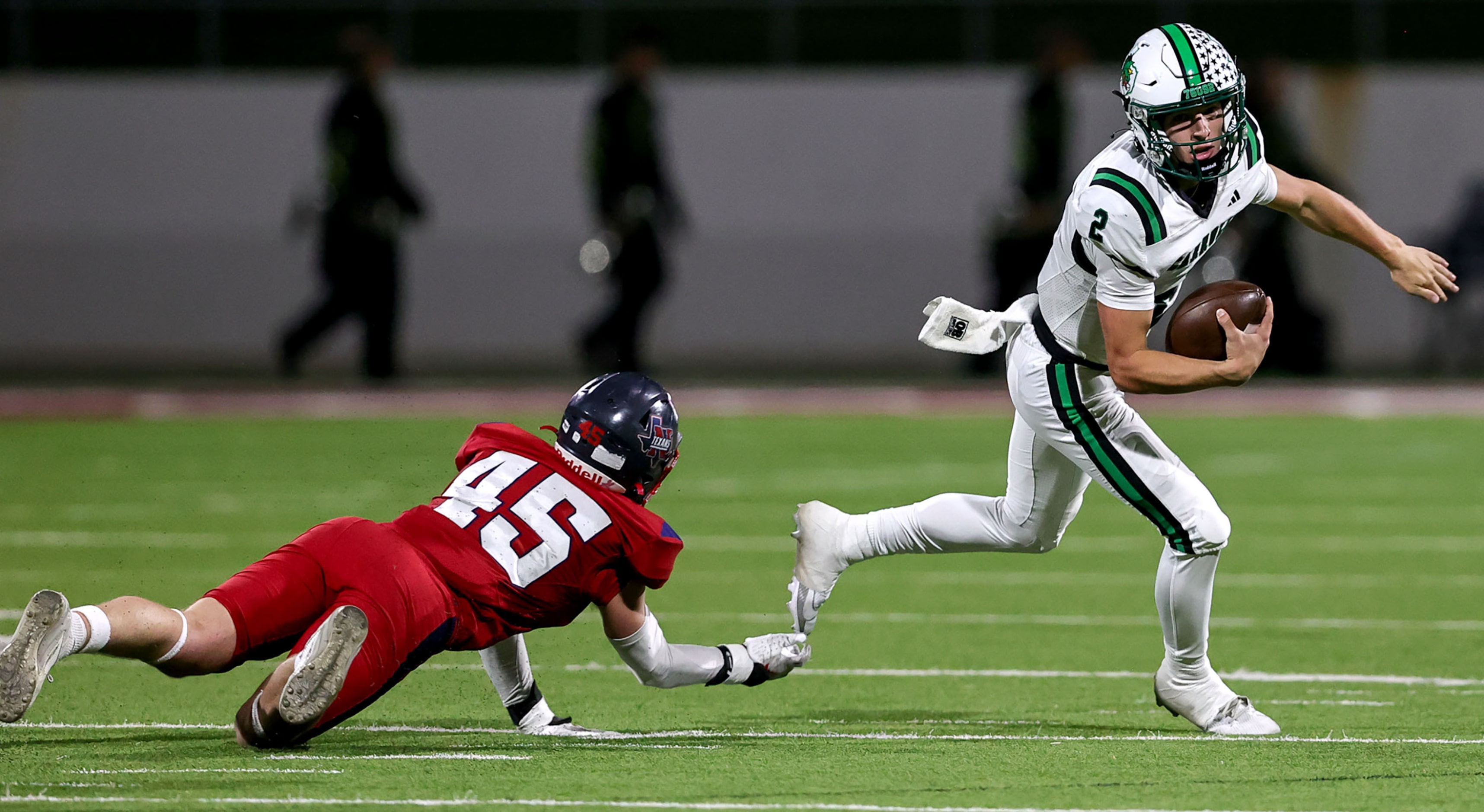 Southlake Carroll quarterback Angelo Renda (2) avoids Justin Northwest linebacker Tristan...