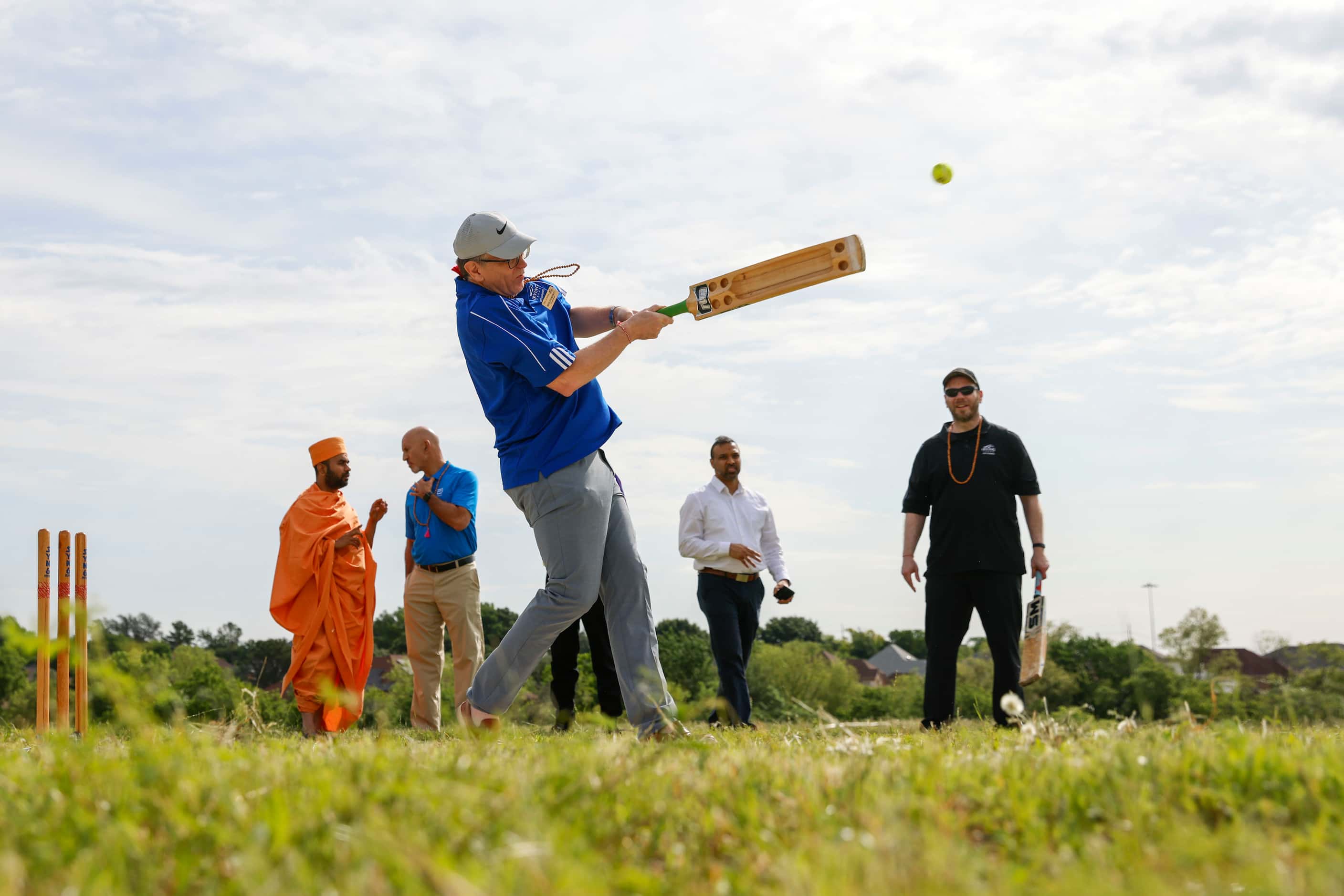 Irving city council member Mark Cronenwett, bats during a ceremonial cricket game ahead of a...