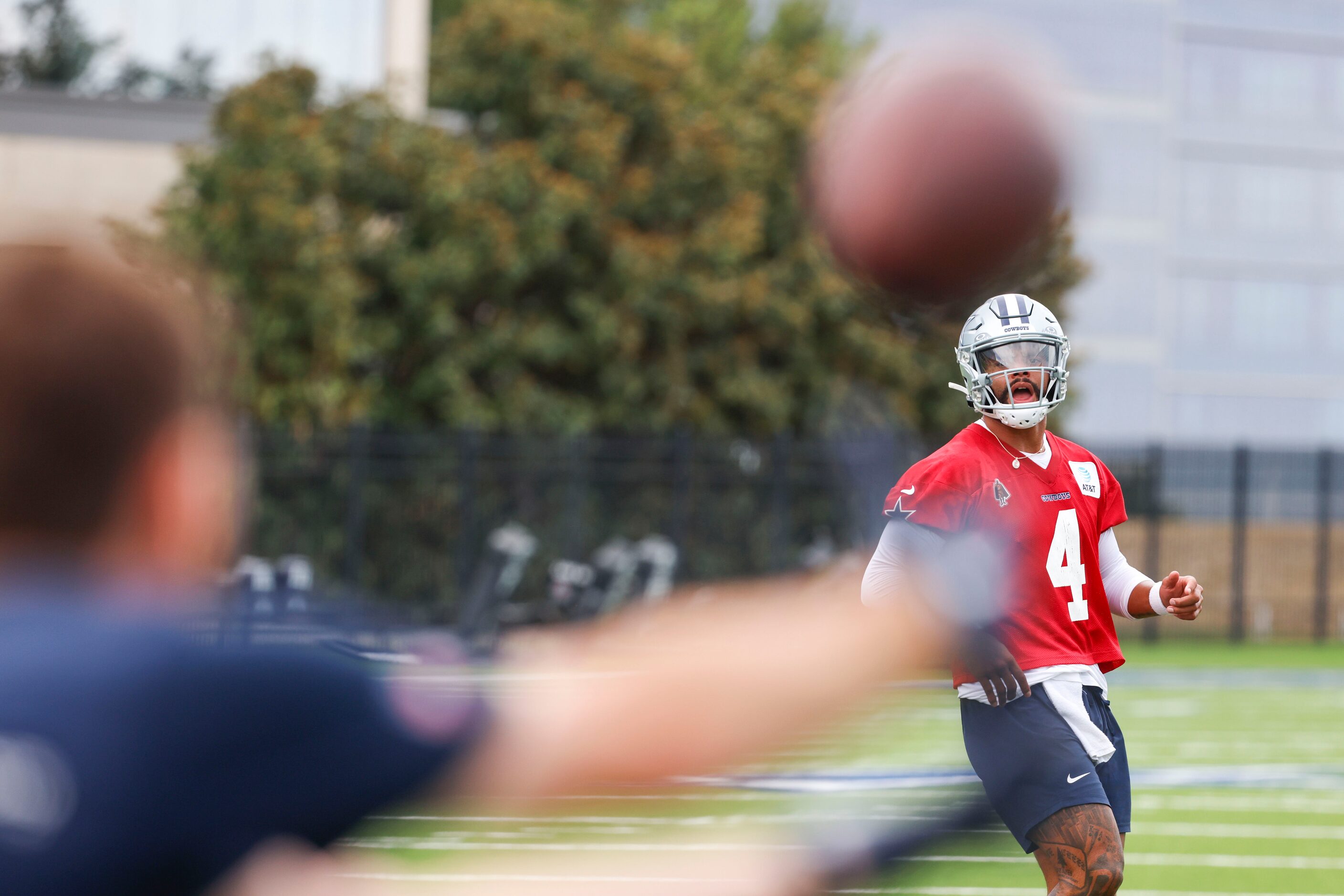 Dallas Cowboys quarterback Dak Prescott (4) runs a drill as he throws the ball during a team...