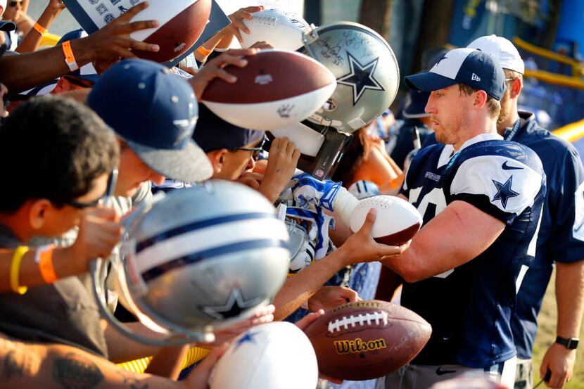 Dallas Cowboys outside linebacker Sean Lee (50) signs autographs for fans following...