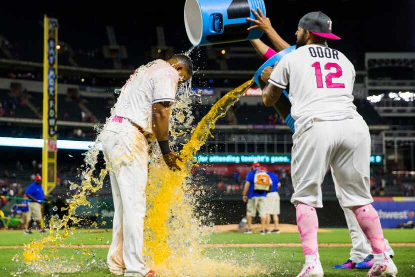 Texas Rangers shortstop Elvis Andrus (1) gets doused with Gatorade by second baseman Rougned...
