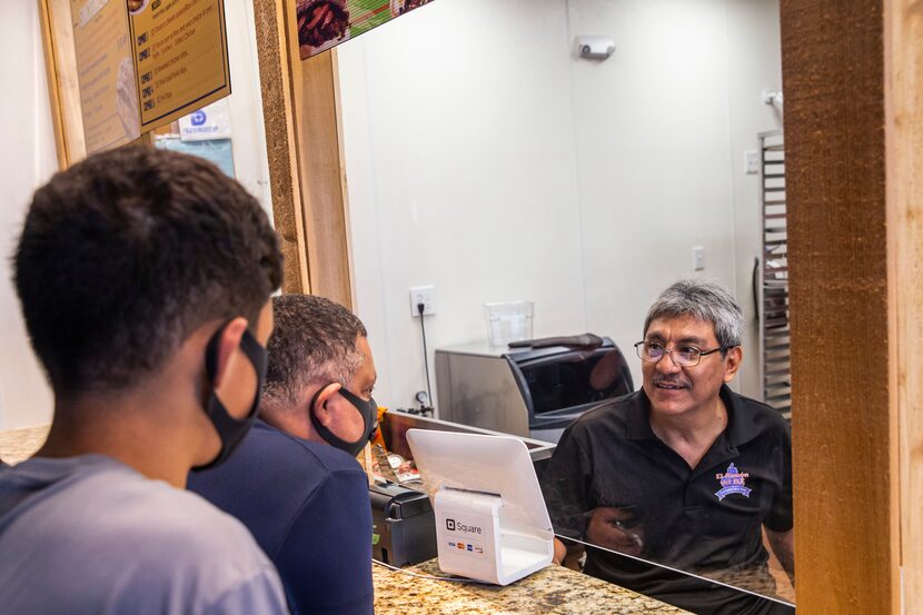 Owner Martín Ramirez takes customer orders at El Rincon del D.F. Mexican restaurant during...