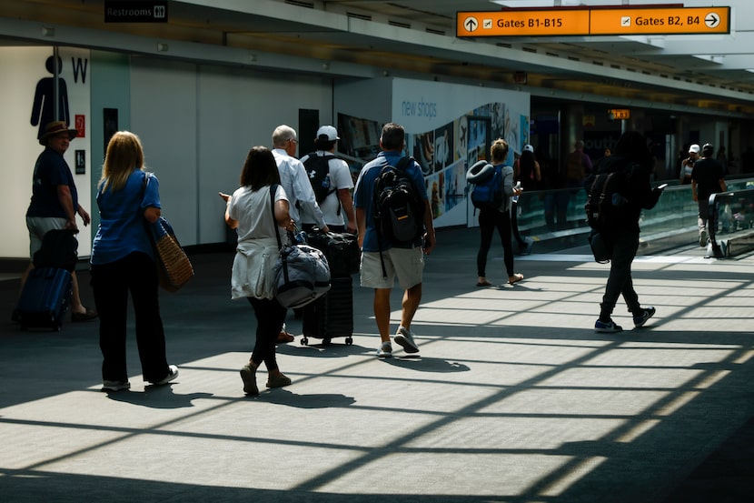 Travelers make their way around the Baltimore/Washington International Thurgood Marshall...