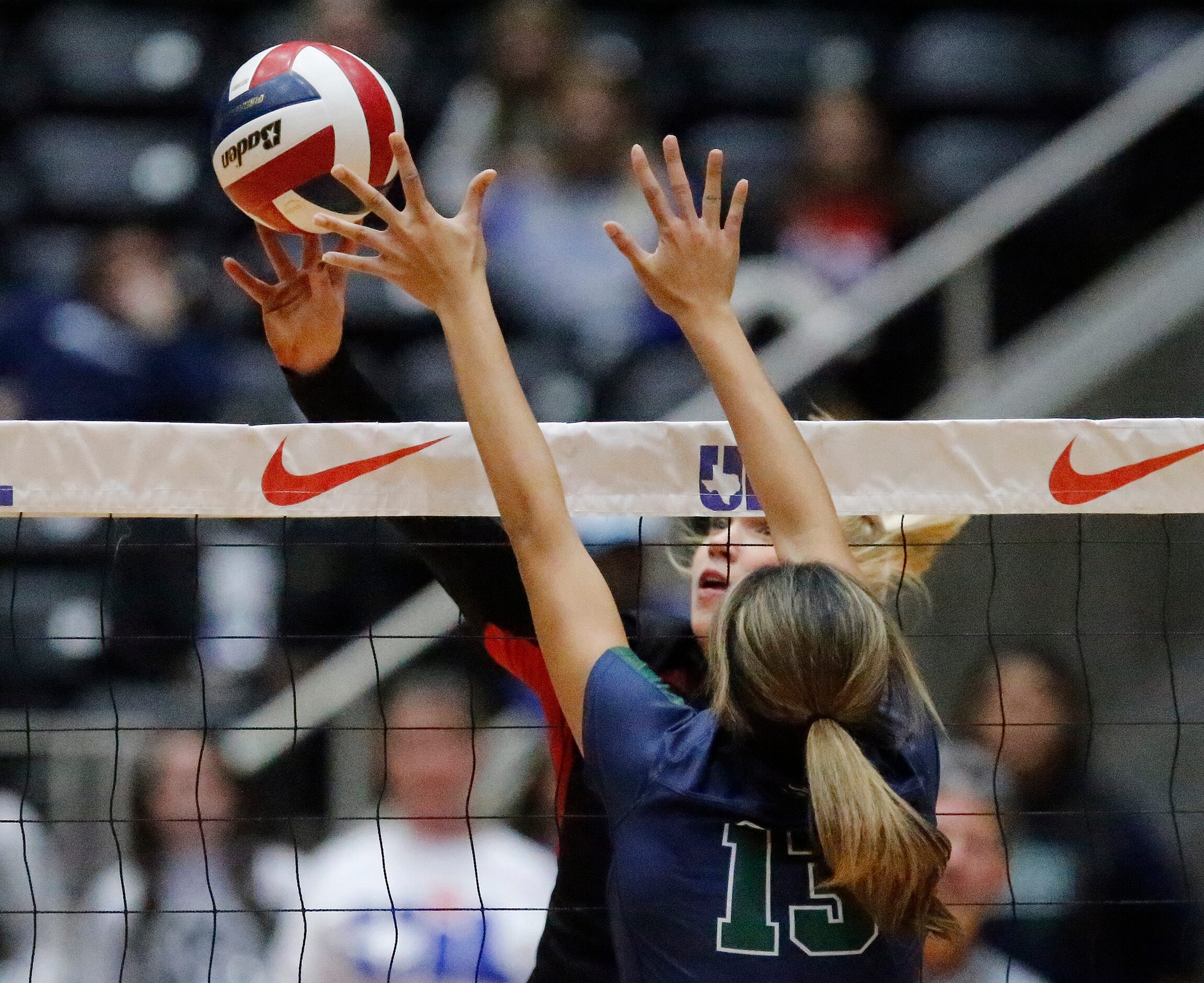 Colleyville Heritage High School's Reagan Engler (15) tips the volleyball past Reedy High...