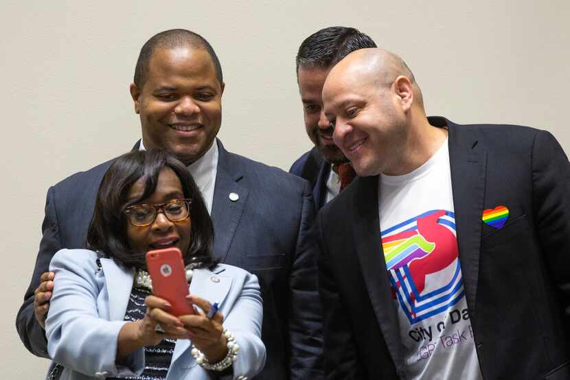 Mayor Eric Johnson (left, second row) takes a photo with council members Carolyn King Arnold...