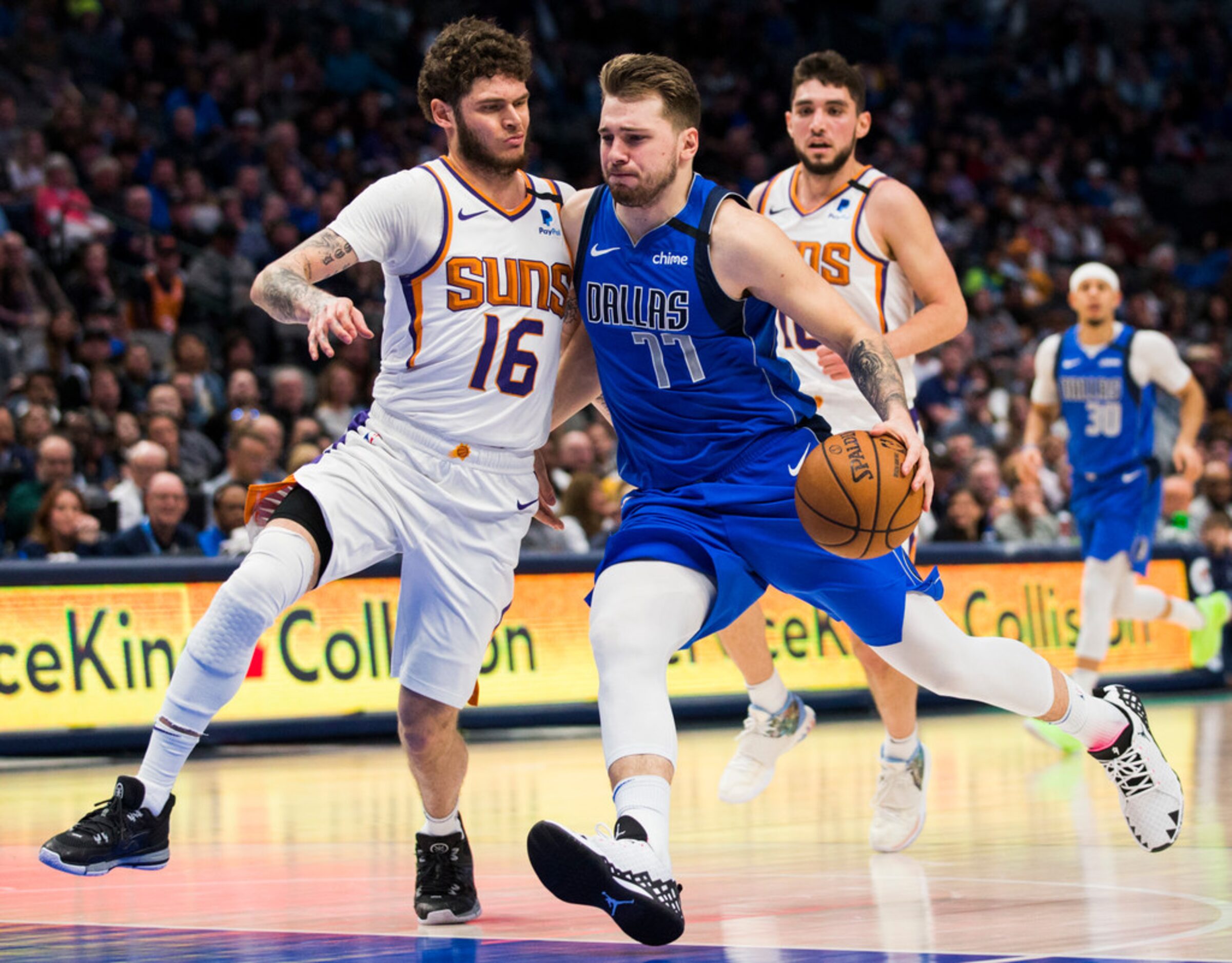 Dallas Mavericks guard Luka Doncic (77) is fouled by Phoenix Suns guard Tyler Johnson (16)...