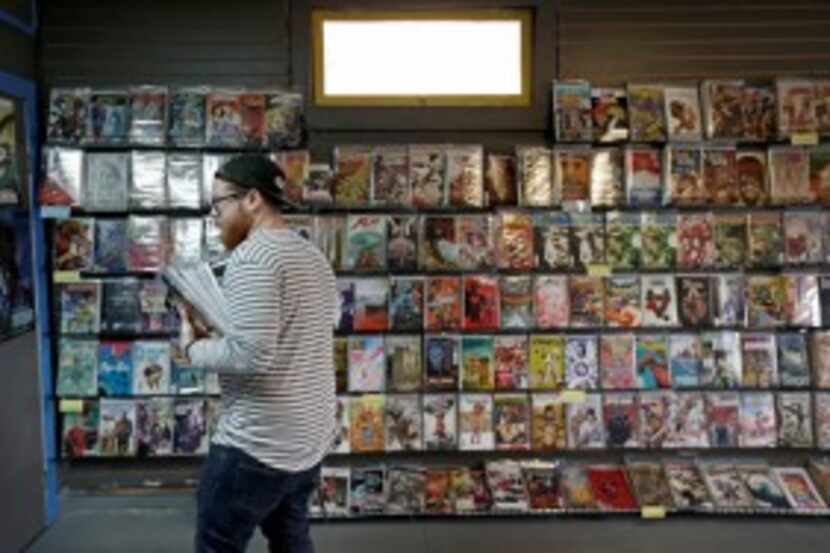  Customer Justin Gorbey shops at Red Pegasus Games and Comics on Wednesday in Dallas. (Jae...