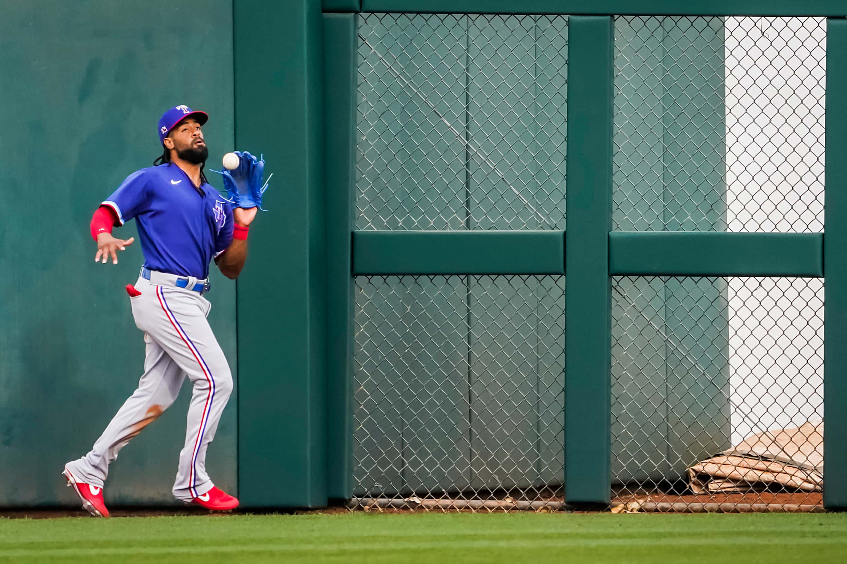 Texas Rangers outfielder Henry Ramos makes the catch on a fly ball by Khali Lee of the...