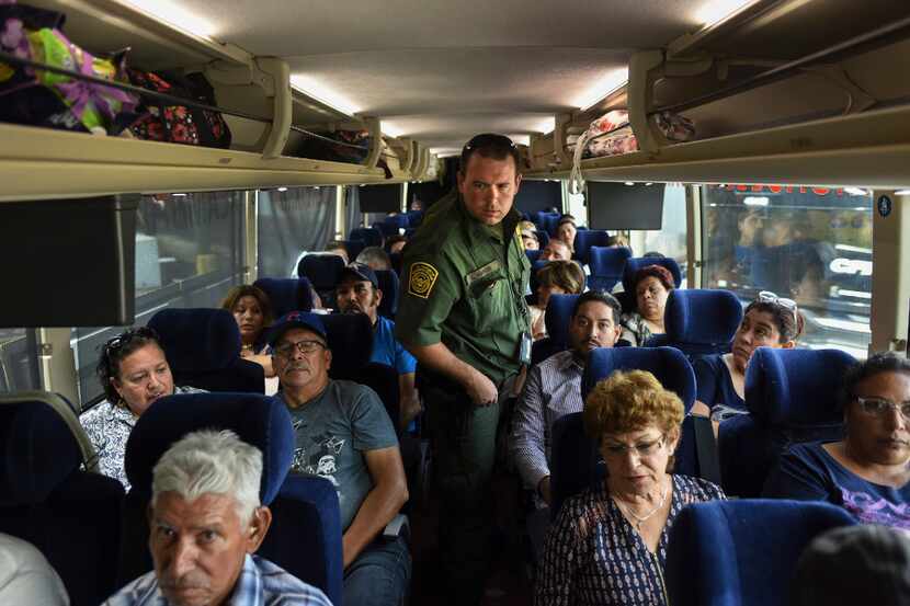 A bus originating in Mexico is inspected by Border Patrol agents, including Capt. L. Rinker...