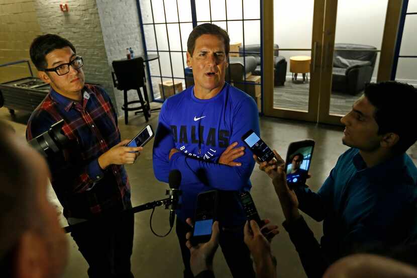 Dallas Mavericks owner Mark Cuban (center) talks with the  media in an interview during the...