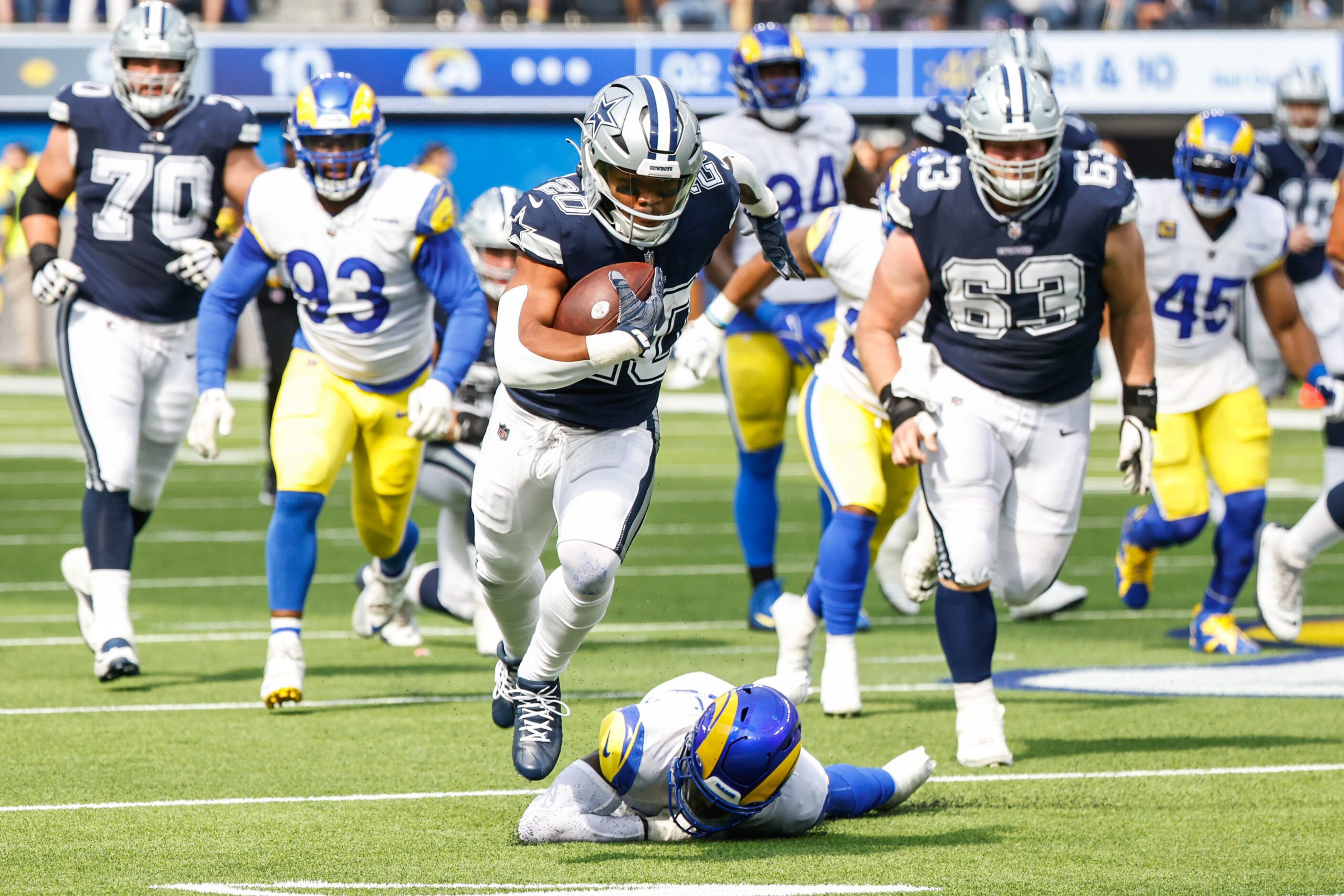 Dallas Cowboys running back Tony Pollard (20) gets past Los Angeles Rams safety Nick Scott...