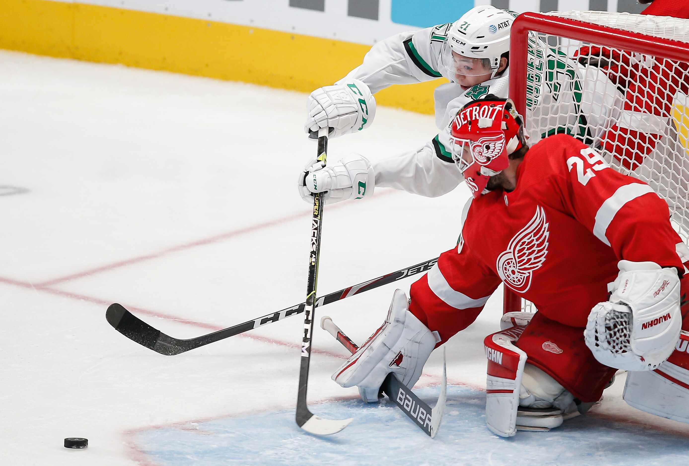 Dallas Stars forward Jason Robertson (21) attempts a wrap-around shot as Detroit Red Wings...