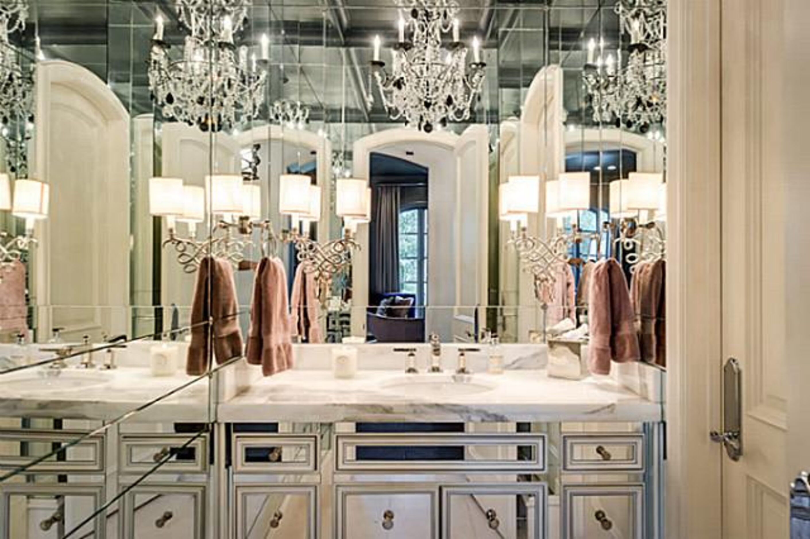 As part of its design, the master bathroom has mirrored cabinets.