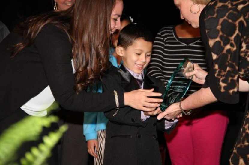 
A young student accepts a Crystal first place award at the 2014 Irving Celebration of...