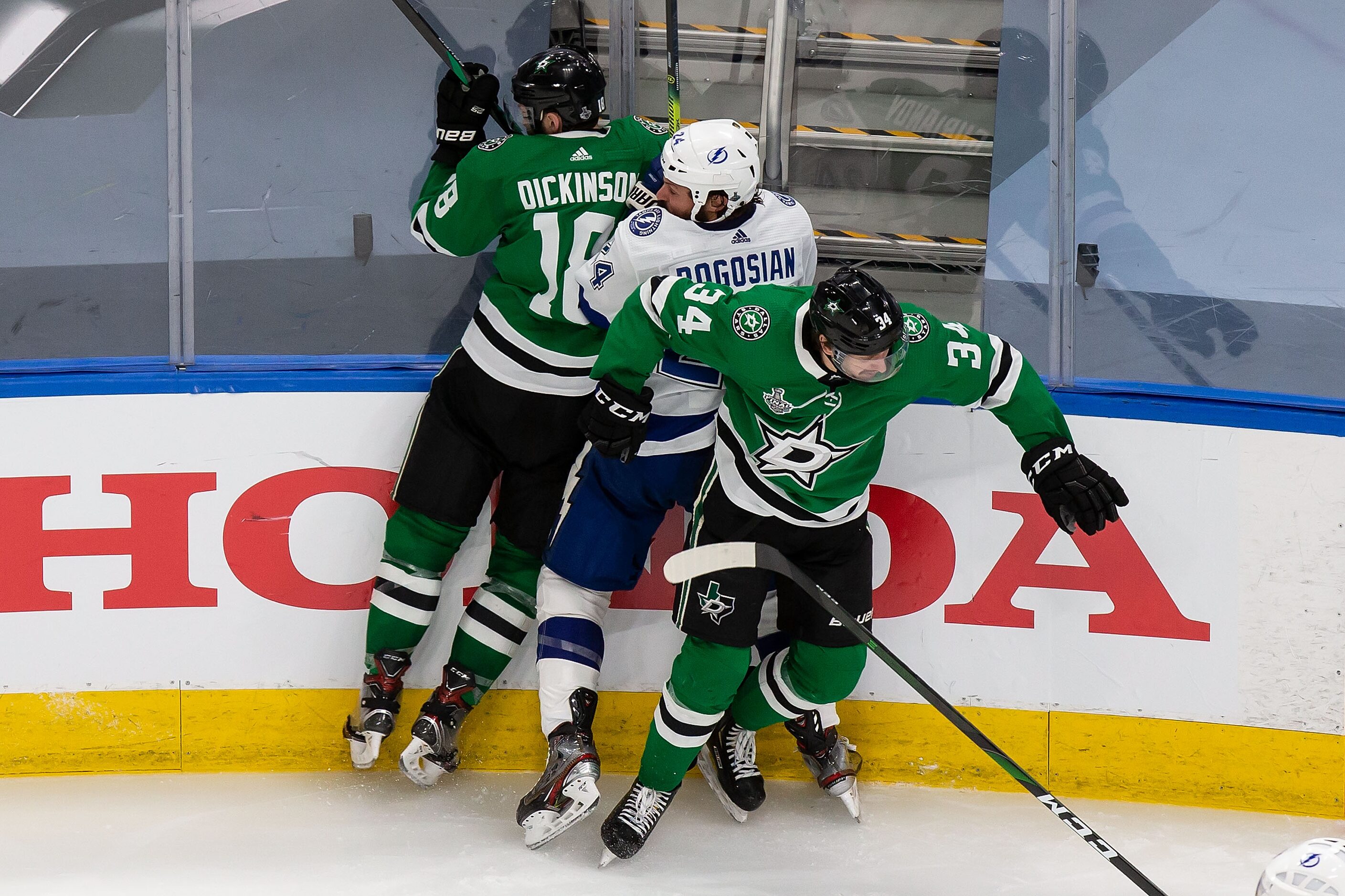 Jason Dickinson (18) and Denis Gurianov (34) of the Dallas Stars battle against Zach...