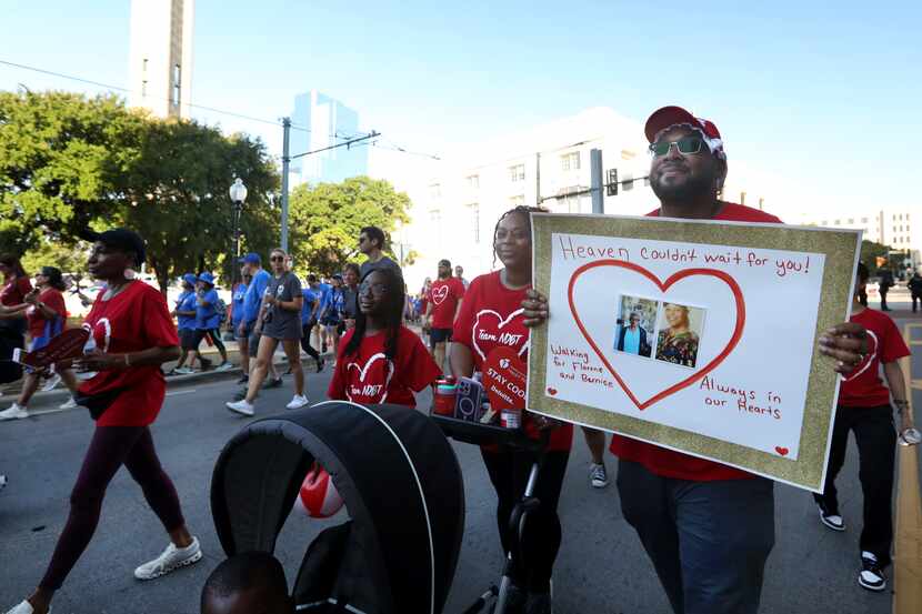 Kenya Buie, right, holds a remembrance sign during The American Heart Association's Annual...