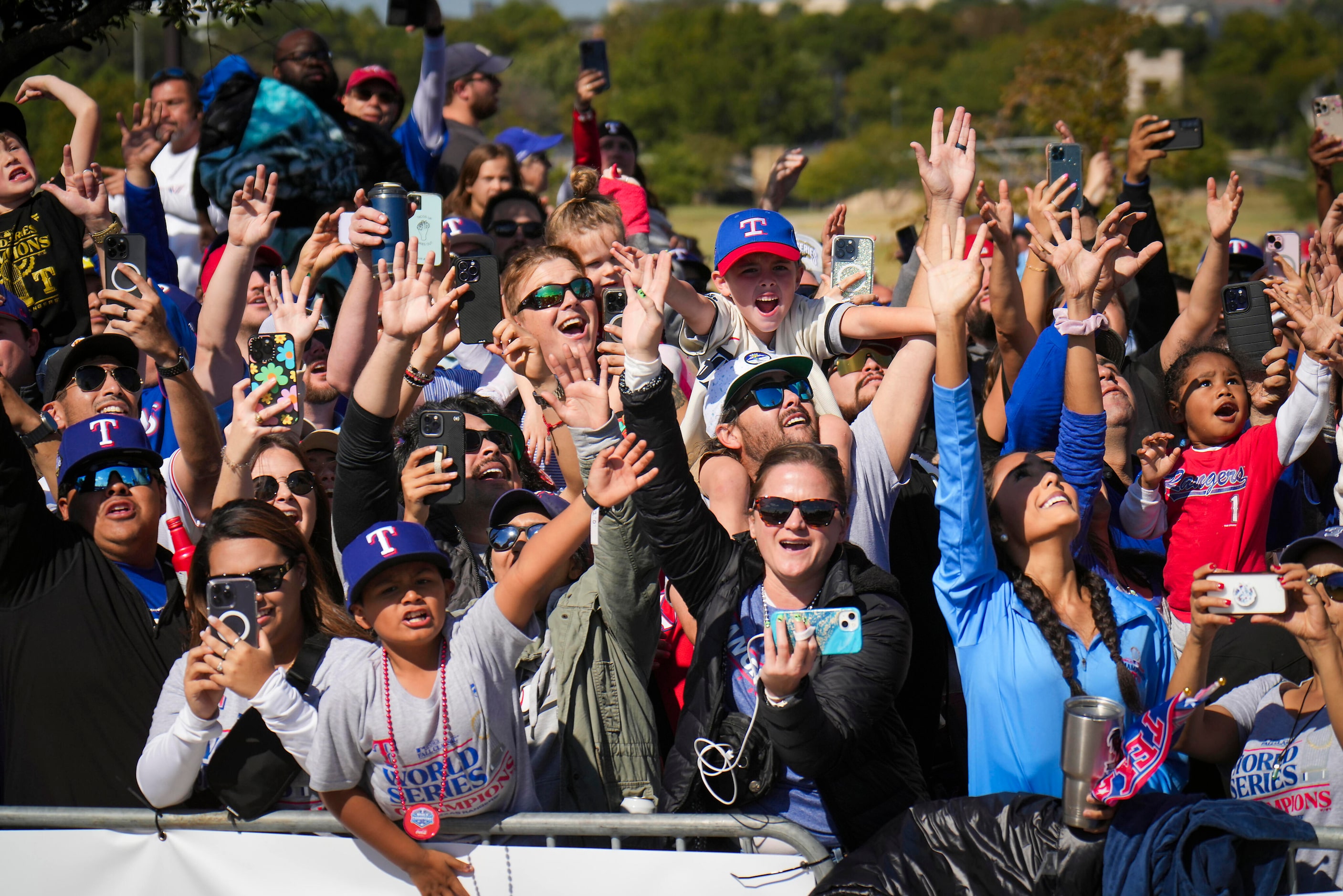 Fans line the parade route during the Texas Rangers World Series victory parade, Friday,...