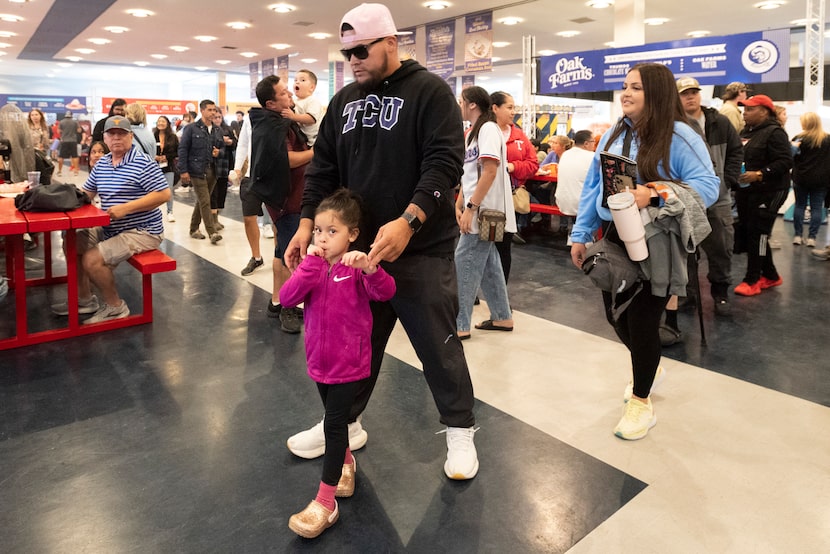 Brian Alonzo, 27, walks with his family including Camila Alonzo, 5, and his wife Cristal...