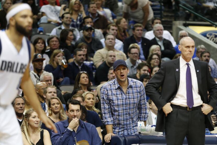 Dallas Cowboys quarterback Tony Romo watches the game behind Dallas Mavericks head coach...