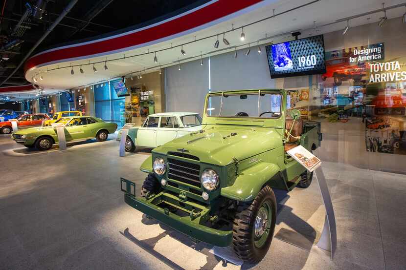 A 1961 Land Cruiser (right) and other vintage Toyota vehicles line the entrance to the...