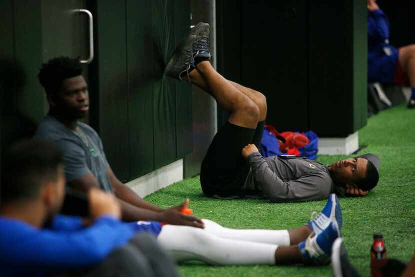 Texas Rangers minor league player Anthony Gose (right) takes a break during training at...